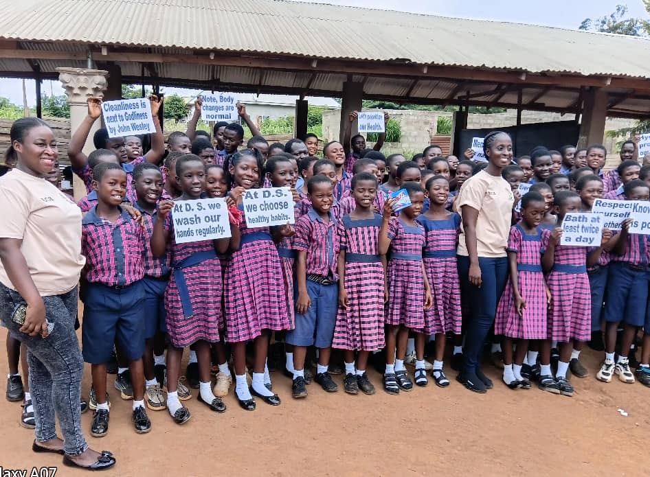 COPSIG NHIS school health initiative — students holding health awareness signs